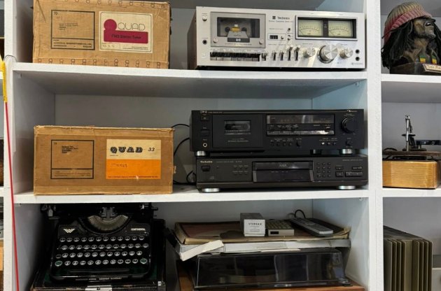 Boxed Quad 33 control unit and Quad tuner beside a Technics cassette deck, a second cassette deck and a Technics CD player on the saleroom shelves at London Camera & Antique Auction Ltd